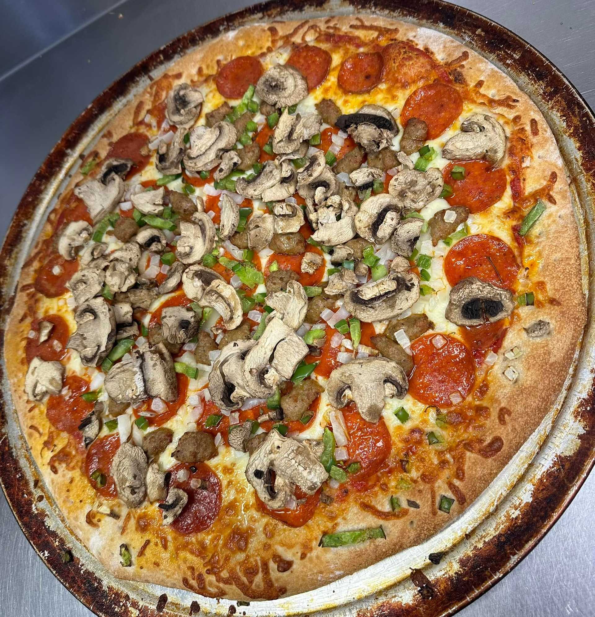 Large pizza with pepperoni, mushrooms, onions, green peppers, and sausage on a thin crust.